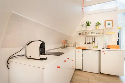 a white kitchen with a toaster on a counter at Zawoja 1725 - Slow Life Cabins in Zawoja