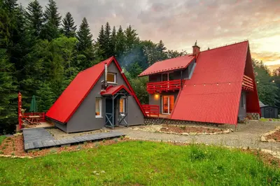 a red roofed house with a red roof at Zawoja 1725 - Slow Life Cabins in Zawoja