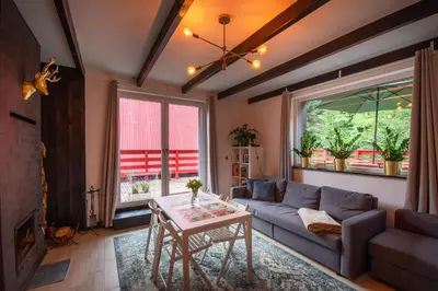 a living room with a couch and a table at Zawoja 1725 - Slow Life Cabins in Zawoja