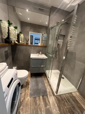 a bathroom with a shower and a toilet and a sink at Way2Stay Rakowicka in Kraków