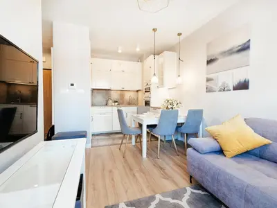 a living room with a couch and a table with chairs at Way2Stay Rakowicka in Kraków