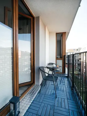 a balcony with a table and chairs on it at Way2Stay Rakowicka in Kraków