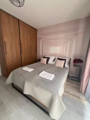 a bedroom with a large bed with two towels on it at Way2Stay Rakowicka in Kraków