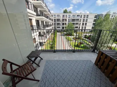 a balcony with two benches and a building at Way2Stay Rakowicka in Kraków