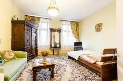 a living room with a bed and a couch at Libro Rooms in Kraków