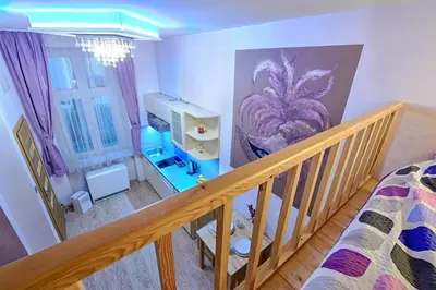 an overhead view of a room with a bed and a staircase at Libro Rooms in Kraków