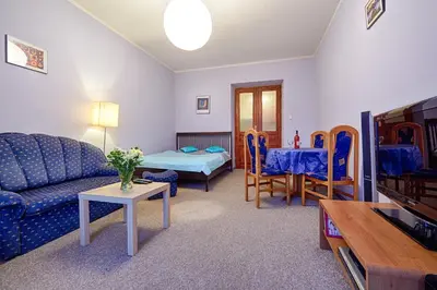 a living room with a couch and a table at Libro Rooms in Kraków