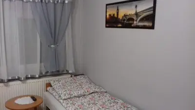 a bedroom with a bed and a picture on the wall at Agroturystyka u Basi in Wola Kalinowska