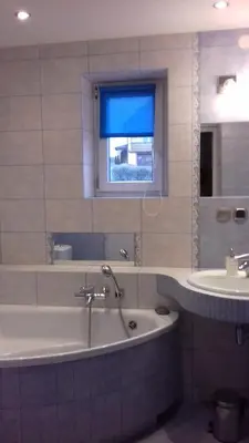 a bathroom with a bath tub and a sink at Agroturystyka u Basi in Wola Kalinowska