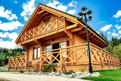 a log cabin with a street light in front of it at Cztery Pliszki in Zawoja
