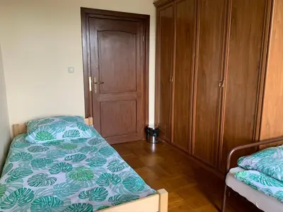 a bedroom with a bed and a wooden cabinet at DOM KKK in Rabka