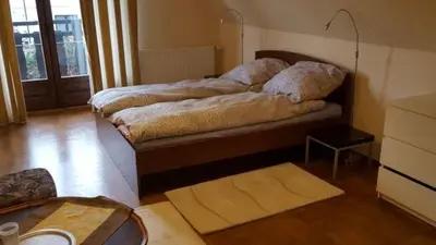 a room with a bed and a table and a room with at DOM KKK in Rabka