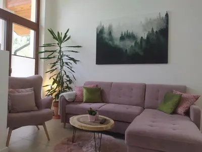 a living room with a purple couch and a table at Między Wierchami in Ponice