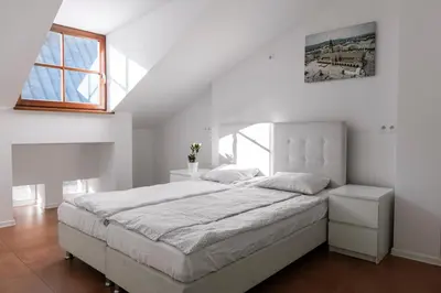 a white bedroom with a large bed and a window at MK Apartment 100m2 Friends&Family in Kraków