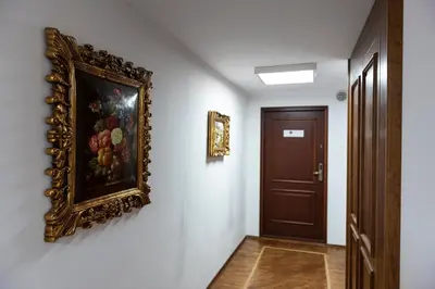 a hallway with a painting on the wall and a door at MK Apartment 100m2 Friends&Family in Kraków