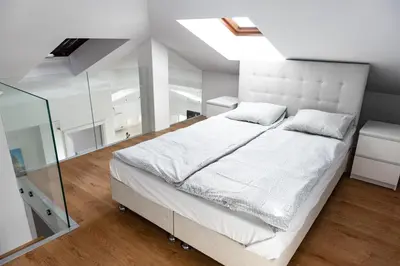 a bedroom with a white bed and a glass wall at MK Apartment 100m2 Friends&Family in Kraków