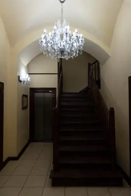 a staircase with a chandelier in a building at MK Apartment 100m2 Friends&Family in Kraków