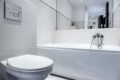 a white bathroom with a toilet and a bath tub at MK Apartment 100m2 Friends&Family in Kraków