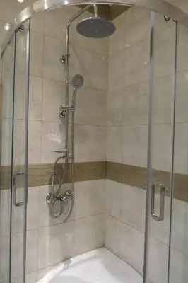 a shower with a glass door in a bathroom at Stare Miasto Zyblikiewicza in Kraków