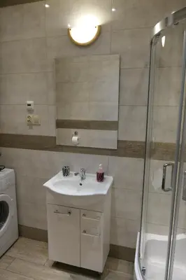 a bathroom with a sink and a shower at Stare Miasto Zyblikiewicza in Kraków