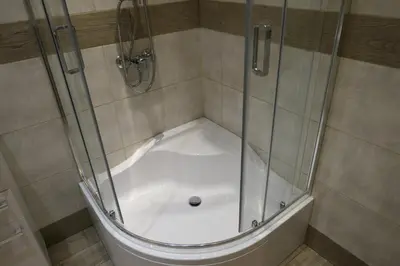 a shower with a glass enclosure in a bathroom at Stare Miasto Zyblikiewicza in Kraków