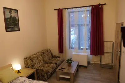 a living room with a couch and a table and a window at Stare Miasto Zyblikiewicza in Kraków
