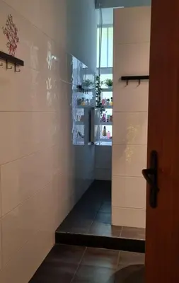 a door leading into a room with a shelf at Green Cat Rooms in Kraków