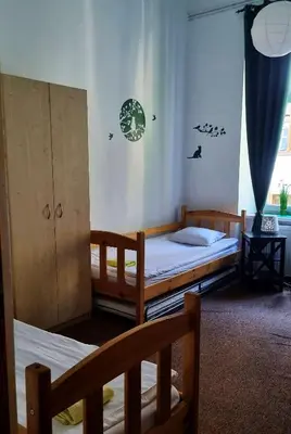 a bedroom with two bunk beds and a window at Green Cat Rooms in Kraków