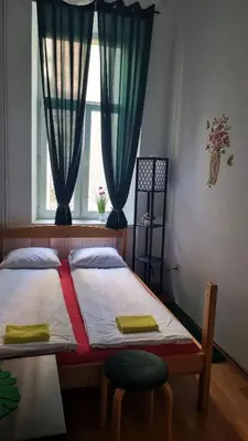 a bedroom with a large bed with a window at Green Cat Rooms in Kraków