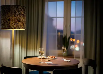 a table with two wine glasses and a plate of food at Starowislna 77 in Kraków