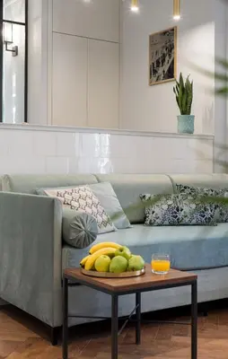 a living room with a couch and a table with fruit on it at Starowislna 77 in Kraków