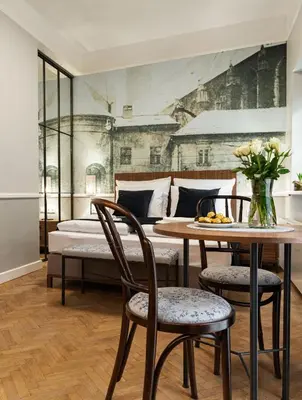 a bedroom with a bed and a table and chairs at Starowislna 77 in Kraków