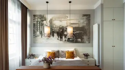 a bedroom with a bed with a picture on the wall at Starowislna 77 in Kraków