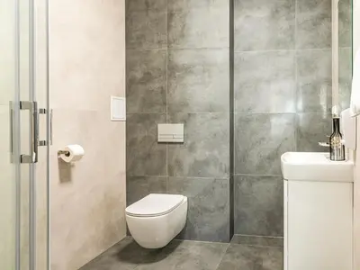 a bathroom with a toilet and a shower at Park Apartamenty Chrzanów in Chrzanów