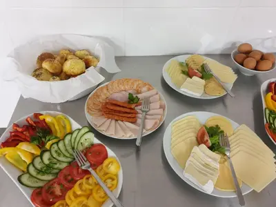 a table full of plates of food with forks at Park Apartamenty Chrzanów in Chrzanów