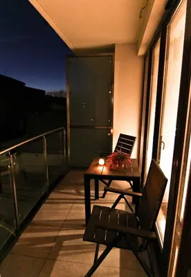 a balcony with a table and a laptop on it at Royal Parkside in Kraków