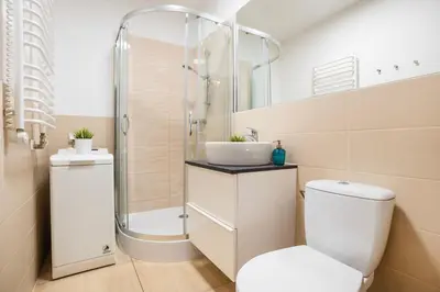 a bathroom with a shower and a toilet and a sink at Perfect place to stay in Kraków City Center in Kraków