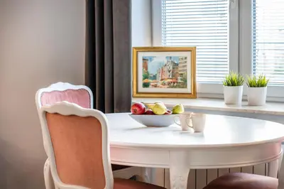 a white table with a bowl of fruit on it in a window at Perfect place to stay in Kraków City Center in Kraków