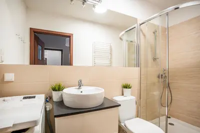 a bathroom with a sink and a shower at Perfect place to stay in Kraków City Center in Kraków
