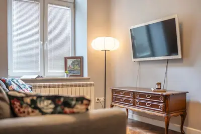 a living room with a couch and a flat screen tv at Perfect place to stay in Kraków City Center in Kraków