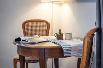 a table with a bottle of wine on top of it at Perfect place to stay in Kraków City Center in Kraków