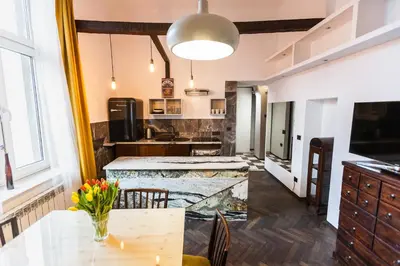 a kitchen with a table and a counter top at Stylish Apartment in Krakow Old Town in Kraków