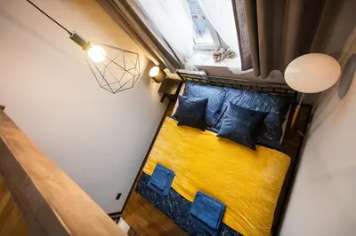 an overhead view of a yellow couch in a room at Stylish Apartment in Krakow Old Town in Kraków