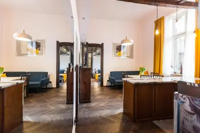 a lobby with tables and chairs in a room at Stylish Apartment in Krakow Old Town in Kraków