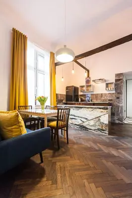 a dining room and kitchen with a table and chairs at Stylish Apartment in Krakow Old Town in Kraków