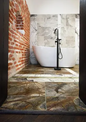 a bathroom with two sinks and a brick wall at Stylish Apartment in Krakow Old Town in Kraków