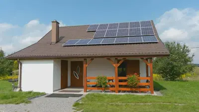 a small house with solar panels on the roof at Domek przy Gościńcu in Golczowice
