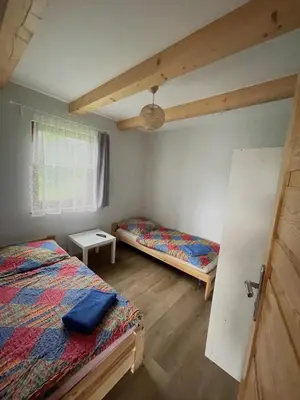 a bedroom with two beds and a window at Domek przy Gościńcu in Golczowice