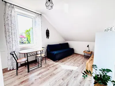 a living room with a blue couch and a table at Apartament Salton in Bochnia