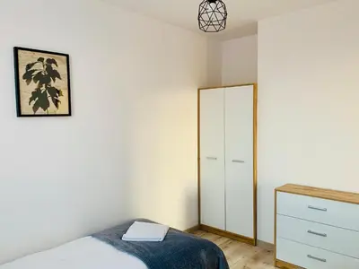 a bedroom with a bed and a dresser and a mirror at Apartament Salton in Bochnia